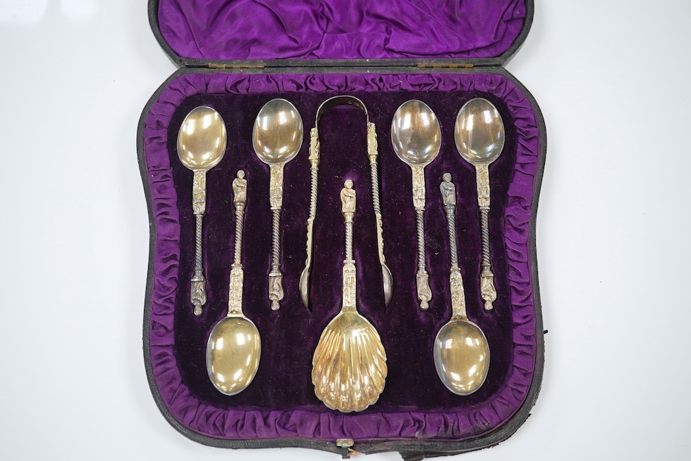 A cased set of six Victorian silver apostle teaspoons, tongs and caddy spoon, 1882, 3.7oz, and a cased George VI silver christening set comprising egg cup, napkin and spoon, 2.6oz. Condition - good.